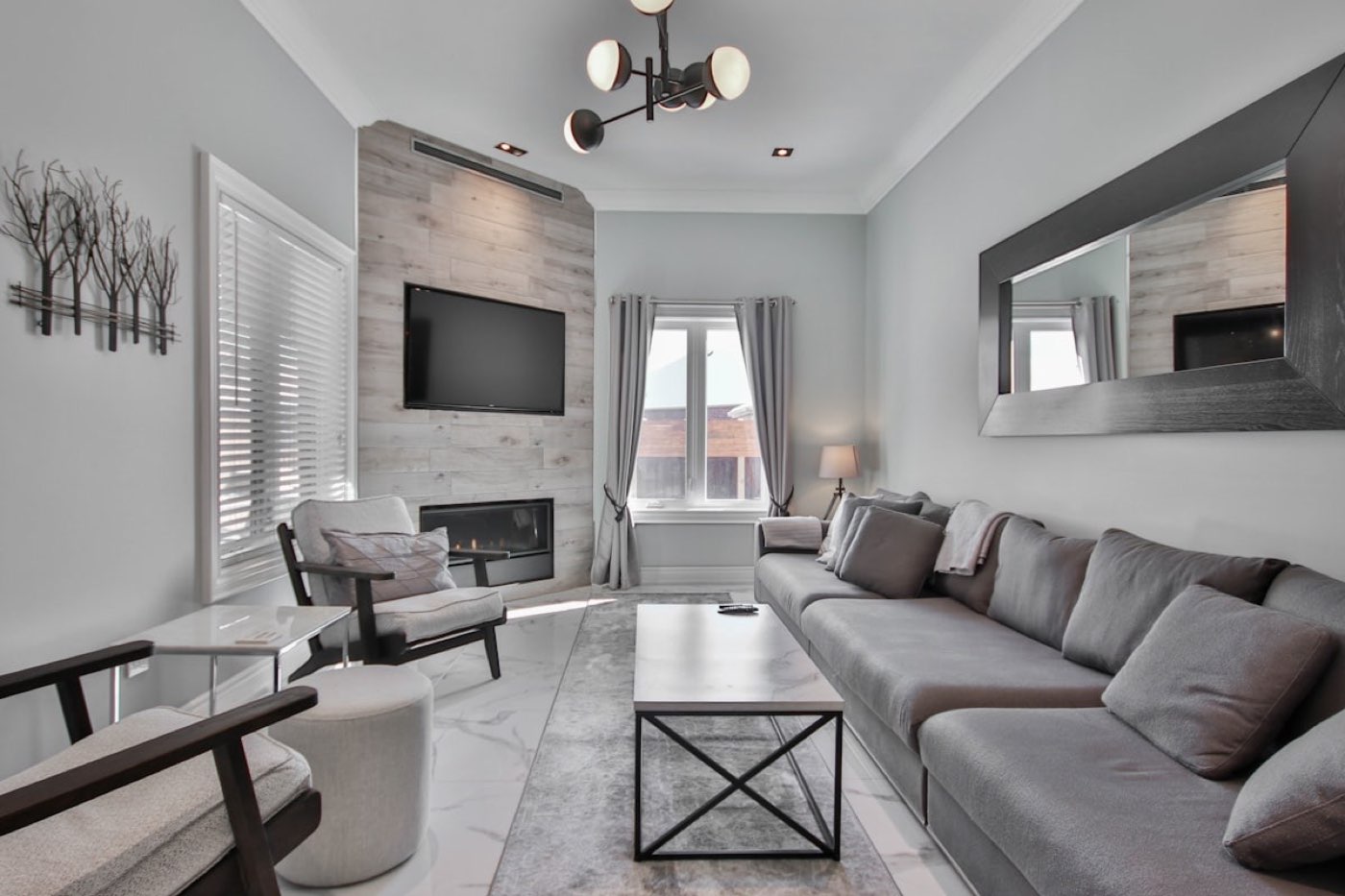 A grey modern living room with a fireplace in a Mallorca apartment