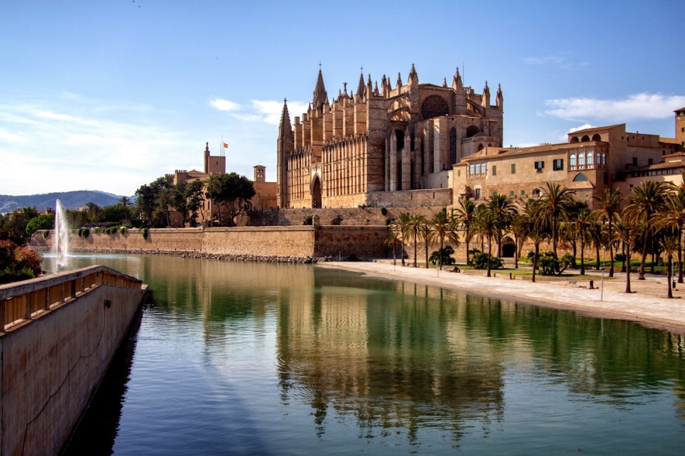 Palma Cathedral mirrored in the still water below the old city