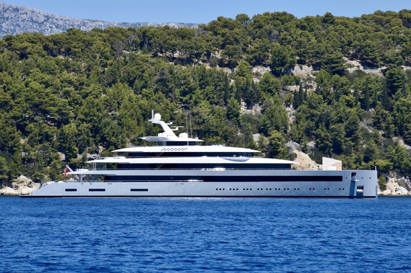 A sleek modern superyacht cruising the Mallorca coastline